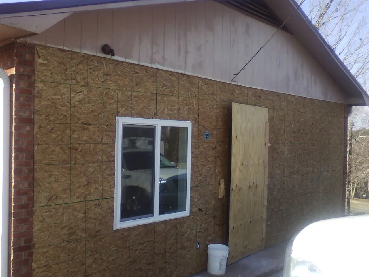 OSB sheathing on a garage addition wall before siding in Washington